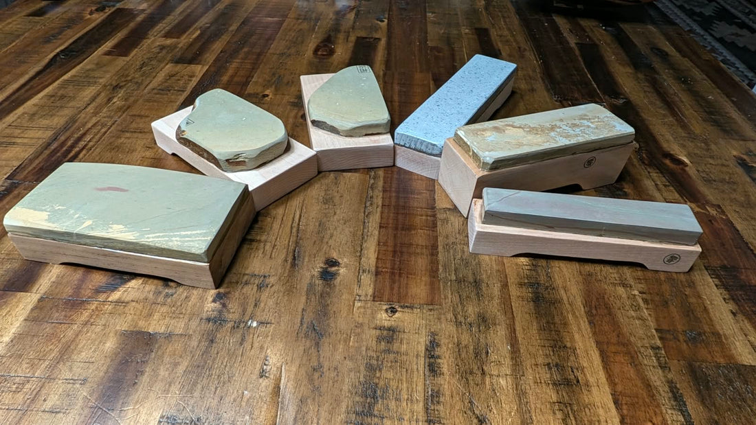 A group of Daitsuki toishi - JNAT stones that have been mounted on a wooden base.