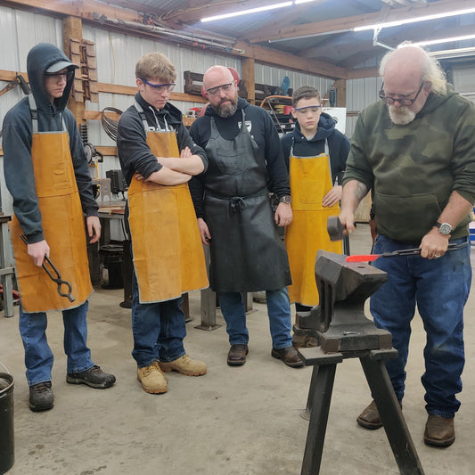Blade forging instruction in progress at Dust Bowl Knives.